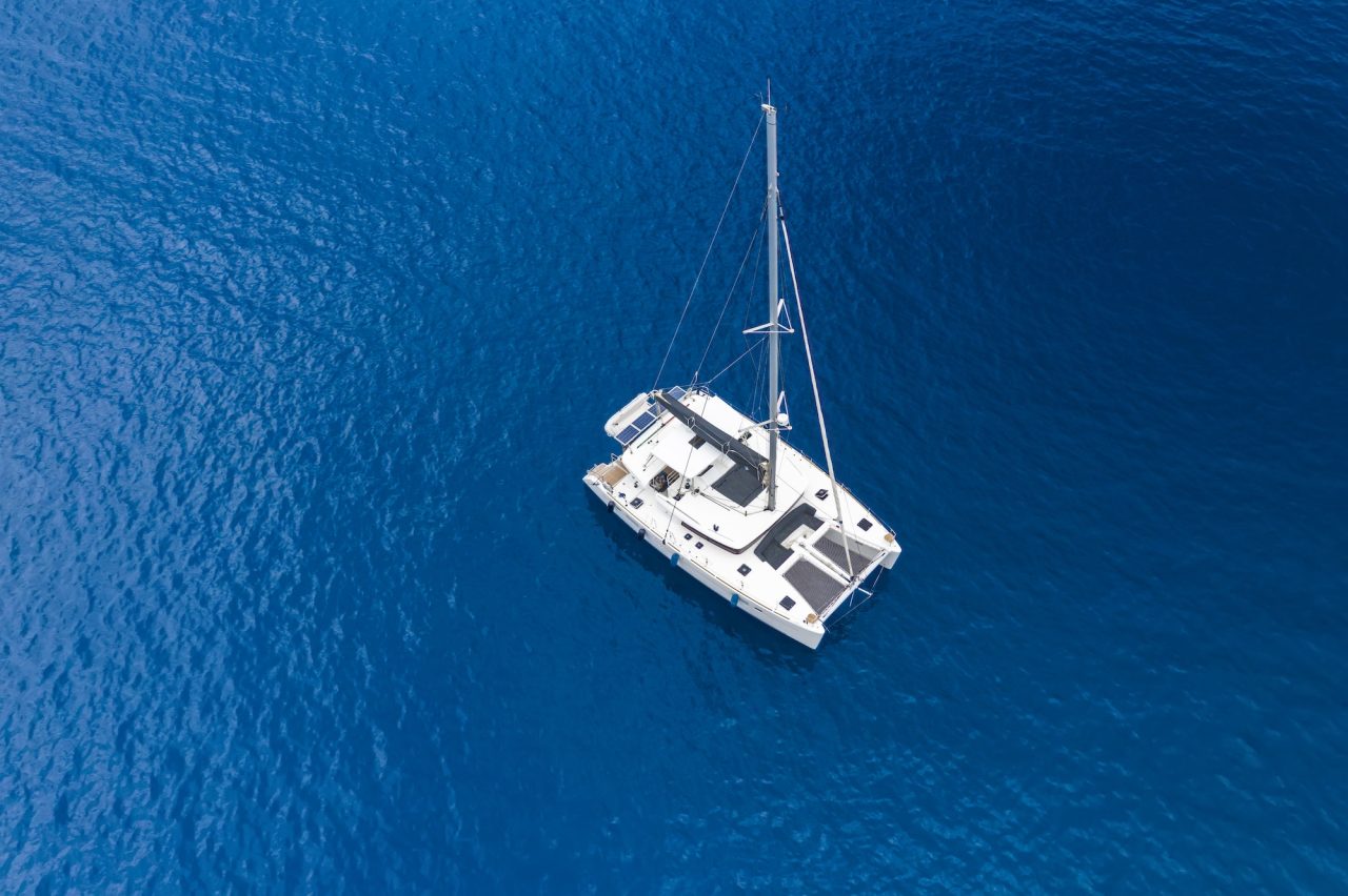 aerial-view-of-a-catamaran-yacht-in-the-blue-sea-yachting-luxury-vacation-at-sea.jpg